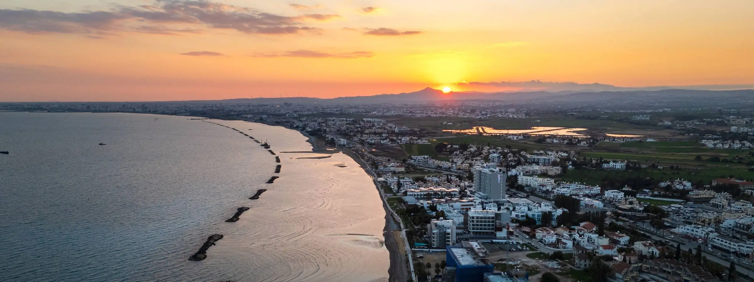 Cyprus coastline at sunset, aerial view